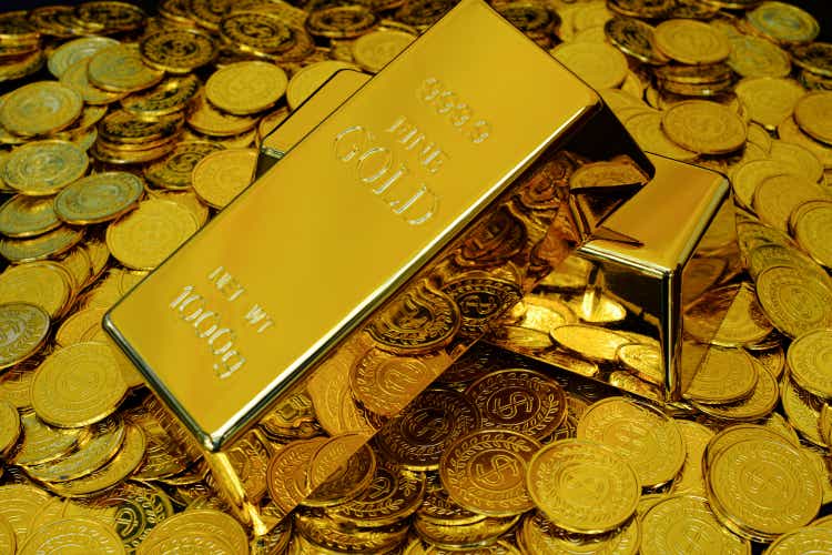 Gold bullion on pile golden coins a lot of
